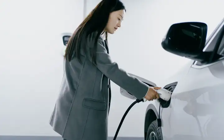 White electric vehicle being recharged