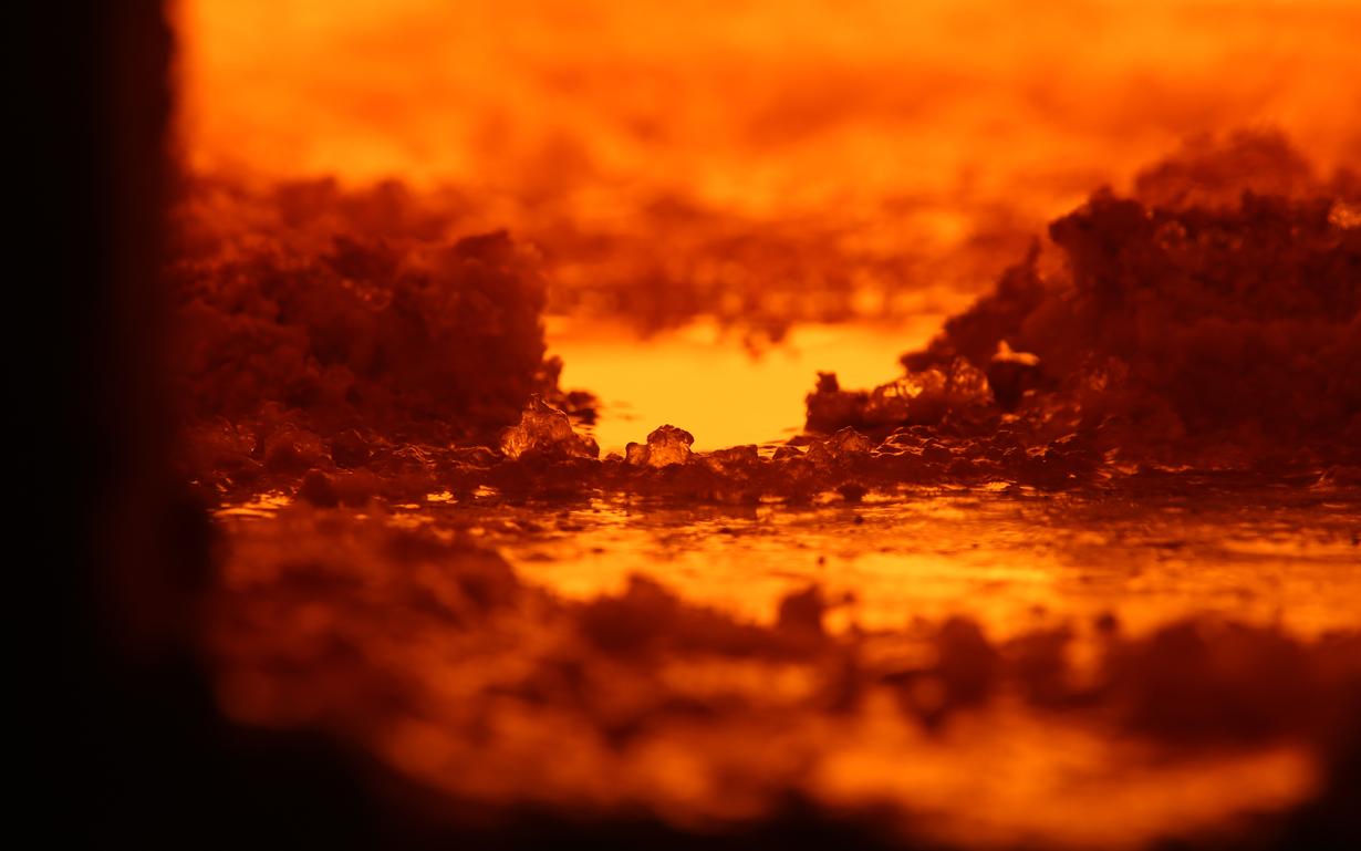 View inside the glass furnace with orange embers