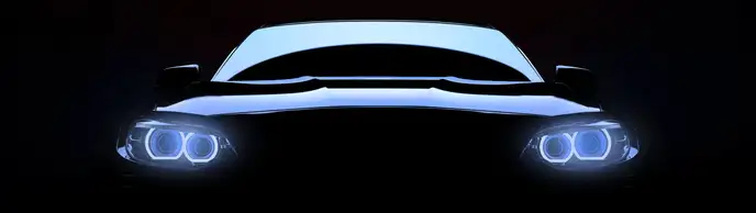 Front view of a luxury vehicle with headlights on