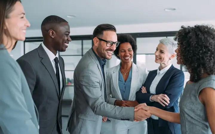 Men and women in business suits meeting