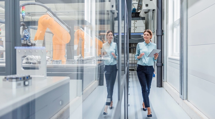 Young female walking down a corridor in an industrial workplace