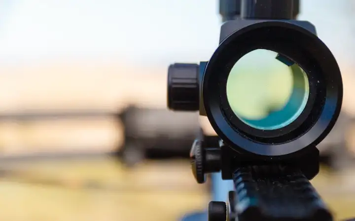 Close up of a rifle sight with blurred background