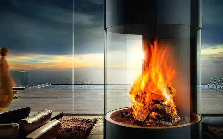 Large fireplace with round viewing-panels in front of a scenic view