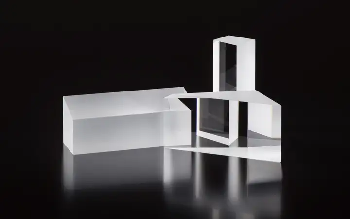 Three glass prisms of different shapes