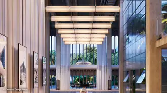 Lobby area of a modern office building with large glass ceiling light 