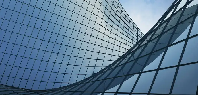 Curved glass roof showing reflections of the sky 