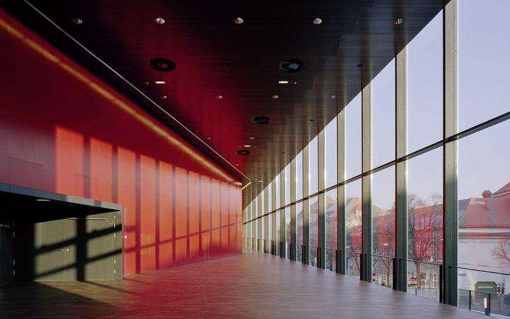 Floor-to-ceiling glass wall with dark metal frame