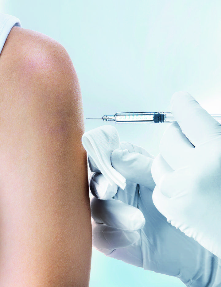 Close up of a female arm receiving an injection