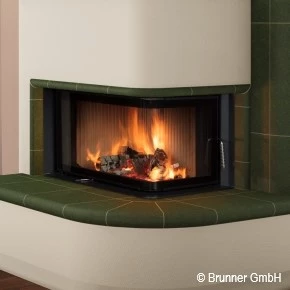 Indoor fireplace surrounded by green tiles with SCHOTT ROBAX® angular bent fire-viewing panel