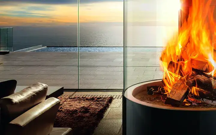 Burning fire in an outdoor log burner encased in glass