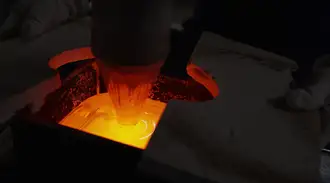 Specially formulated melted glass collects into cubes before become geometric reflective waveguides for AR smart glasses.