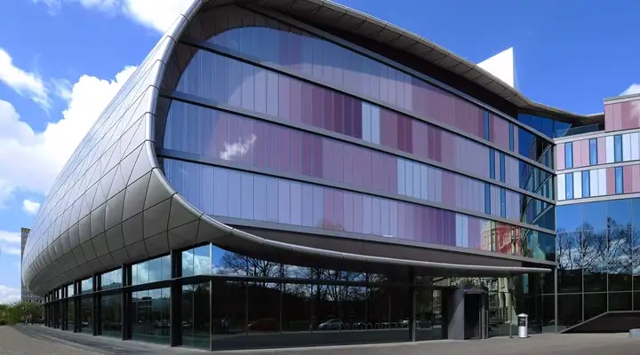 Curved building with wall made using glass panels