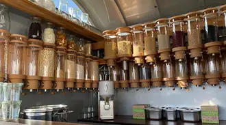 Interior of a hawos mobile store with line of glass tubes containing dry goods