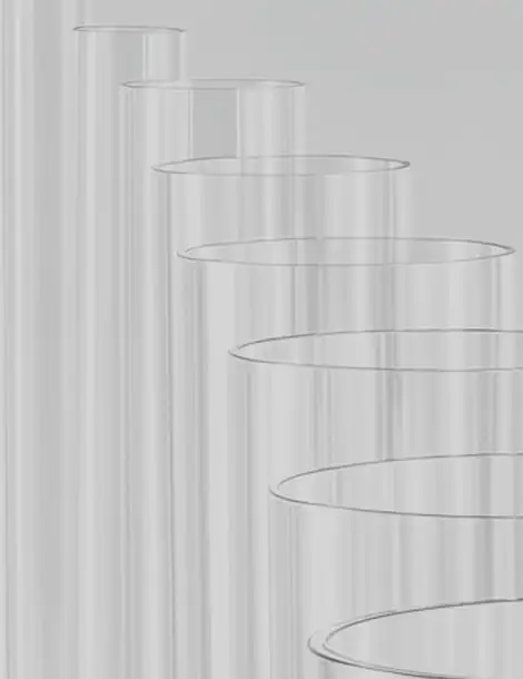 A collection of transparent glass tubes arranged in ascending order of diameter against a light gray background.