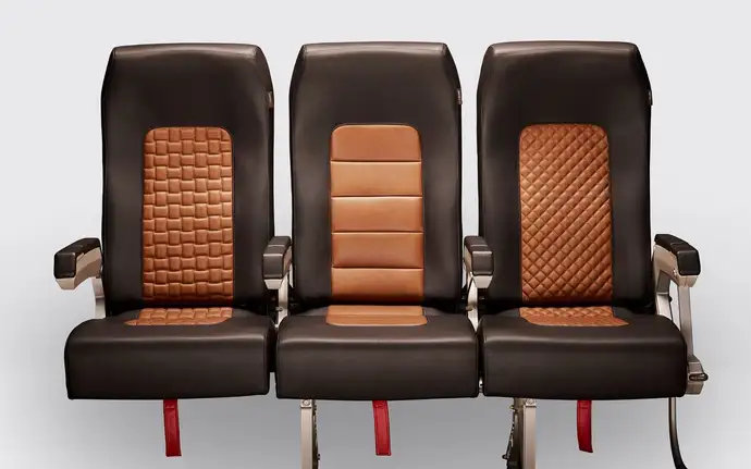 A row of airplane seats with flame retardant treated leather