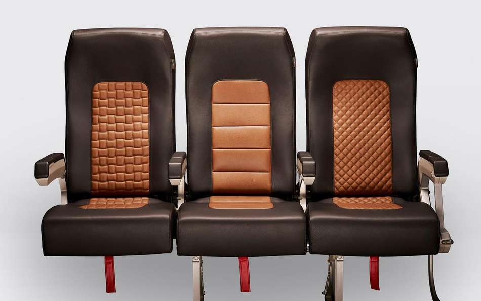 A row of airplane seats with flame retardant treated leather