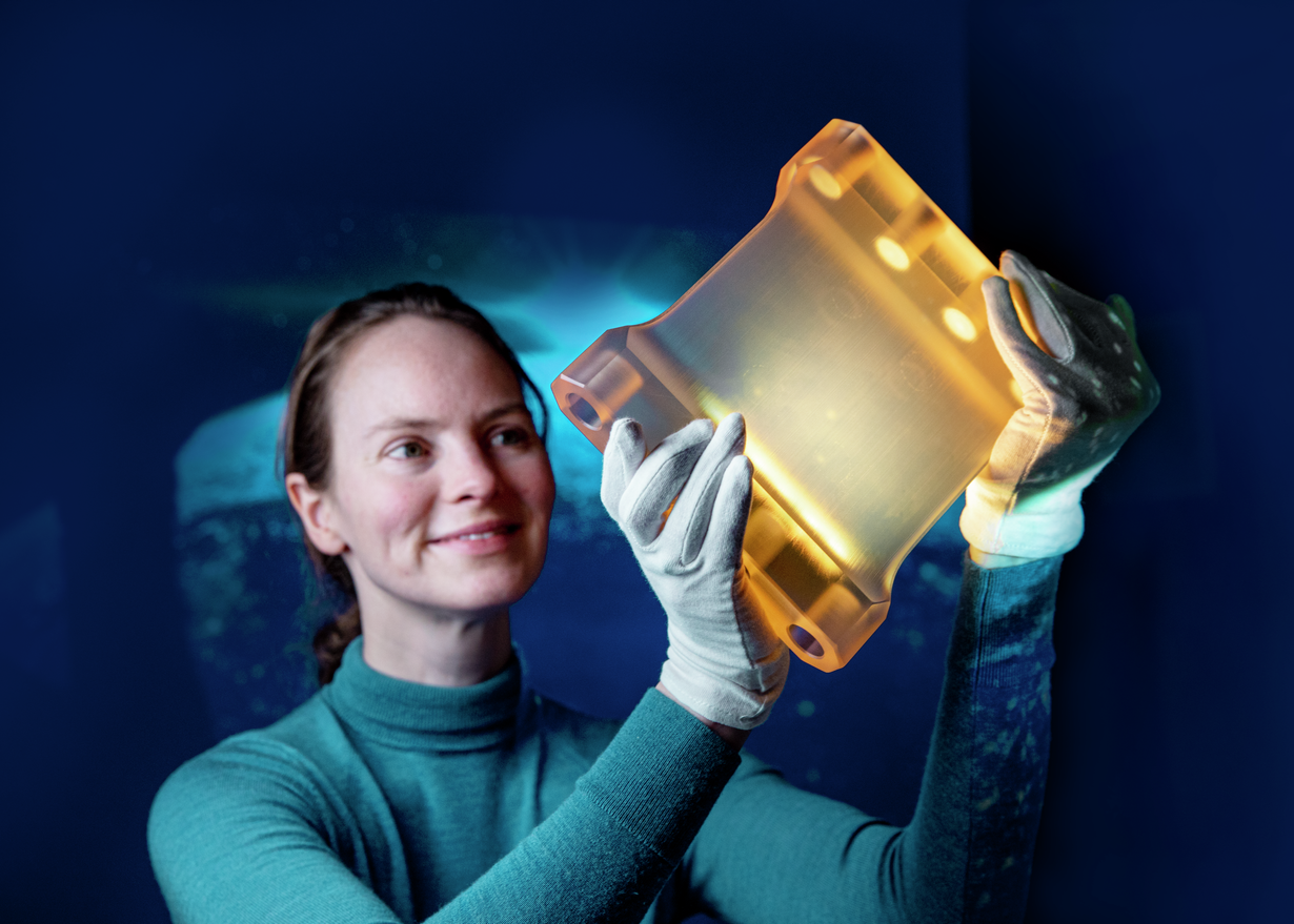 Woman holds piece of ZERODUR® glass ceramic from SCHOTT