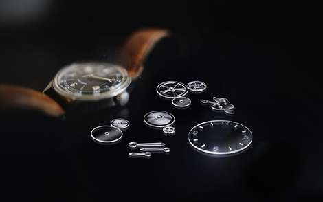 Glass components of a watch on a black background