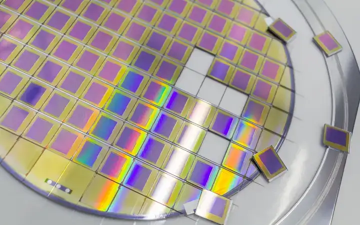 Silicon wafer with microchips in a steel frame holder with separate microchips