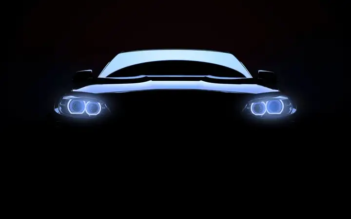 Front view of a car with headlights on in darkness 