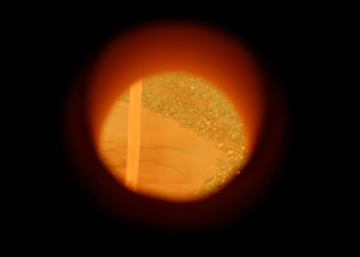 View into the melting tank with liquid glass at up to 1,700 degrees.