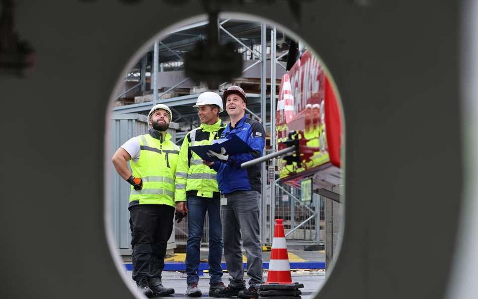 Kaffenberger and colleagues inspect the progress of the project, wearing helmets