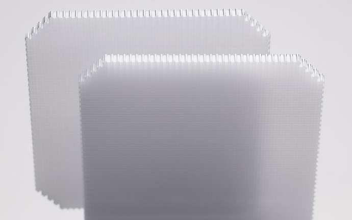 Two structured wafers with a micro-sized checkered design shown in parallel 
