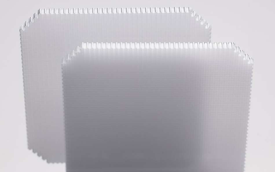Two structured wafers with a micro-sized checkered design shown in parallel 