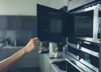 Kitchen microwave oven with open glass door