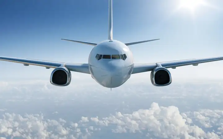 Front view of an aircraft in a blue sky