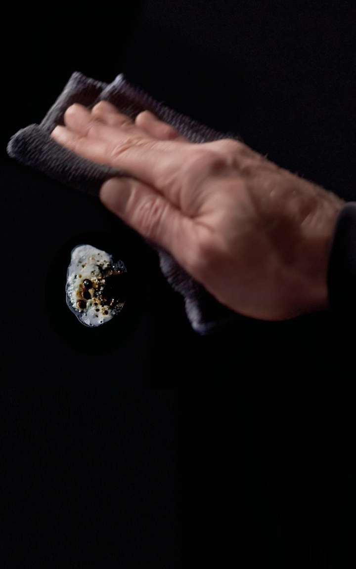 Hand with a hand wipe with dark background