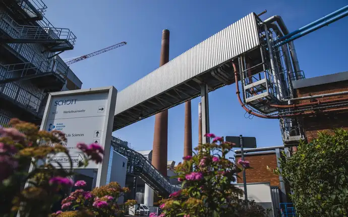 A manufacturing facility surrounded by trees and bushes