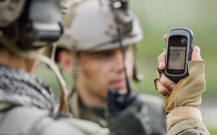 Soldier looking at a rangefinding device