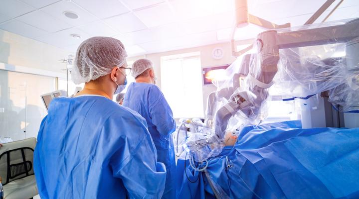 Surgeons in an operating theater with robot