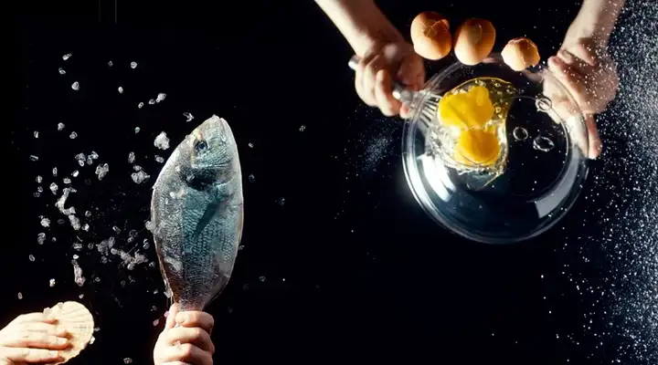 View from below to the top of a cooking situation that takes place on a transparent glass-ceramic cooktop surface
