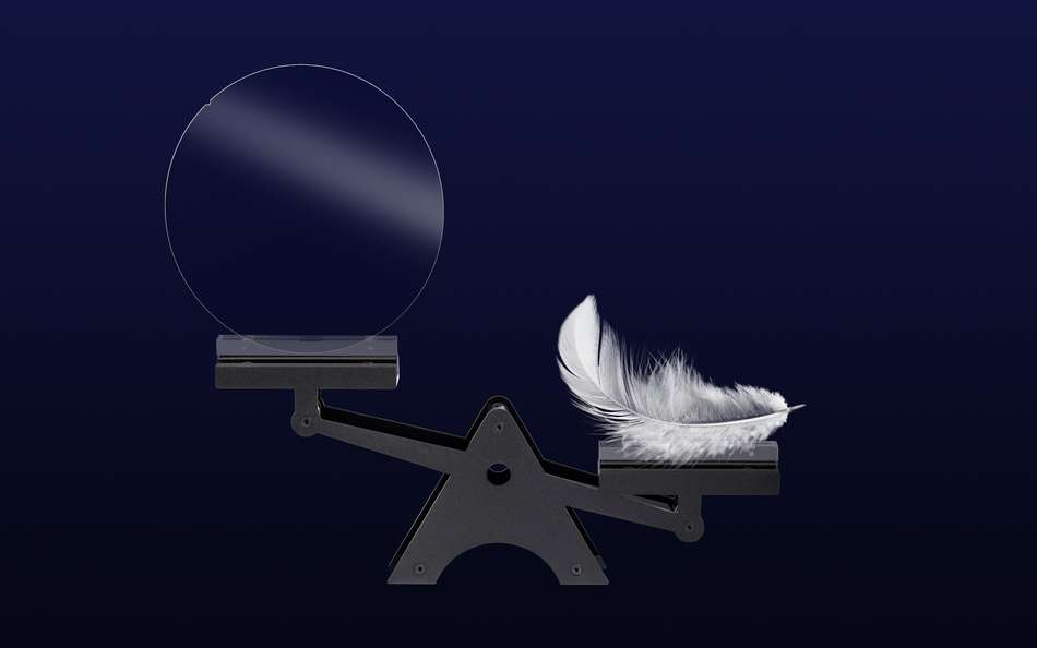 Set of scales weighing a white feather and a glass disc