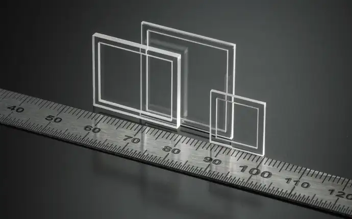 Three SCHOTT® Cavity Caps of different sizes next to a ruler