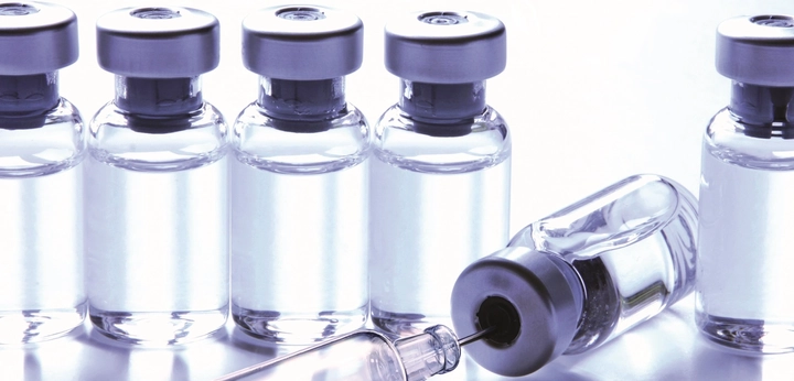 Line of clear glass vials with caps