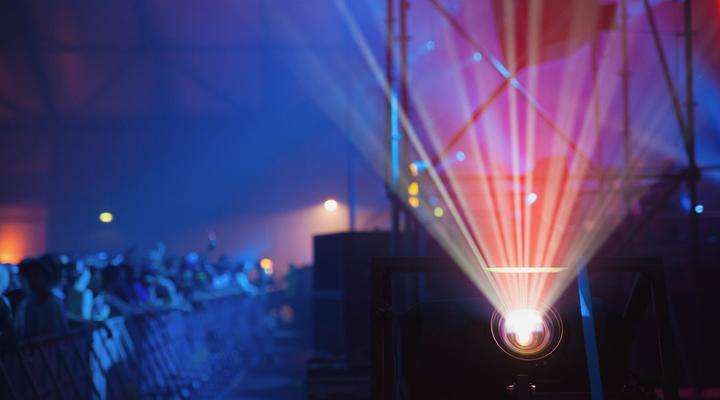 Laser projection with a laser phosphor projector at an event, crowd in the background