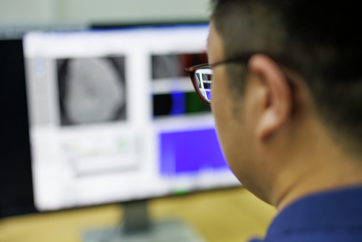 Electrical engineer looking at a screen with technical information and images.