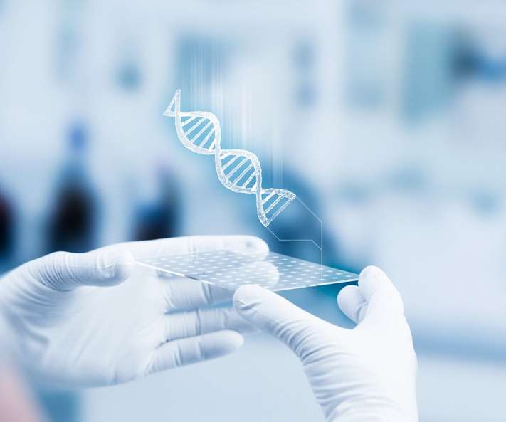 Two hands holding a lab-on-a-chip with a 3D graphic of a DNA helix emerging from it.