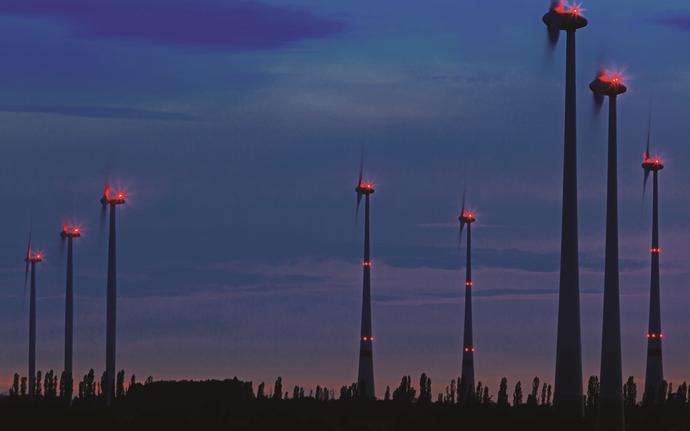 Series of wind turbines at dusk