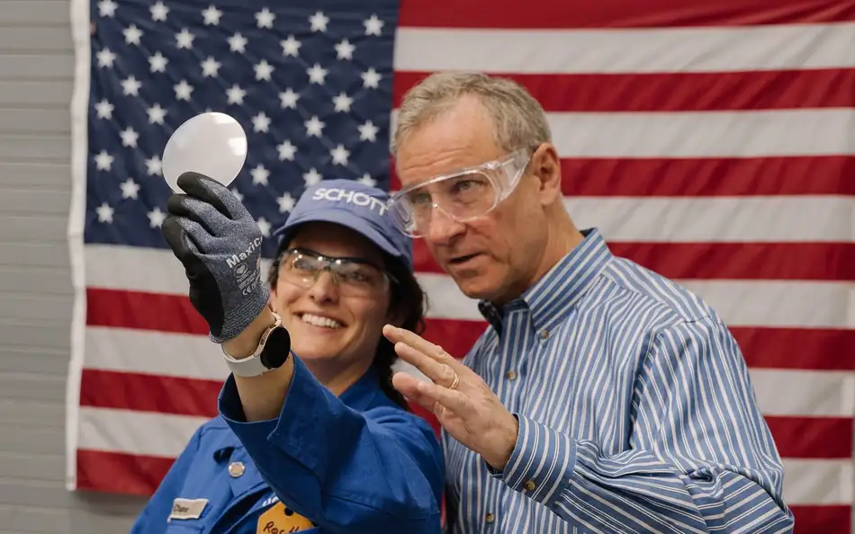 Man holding a launch tube window in his hand with girl next to him