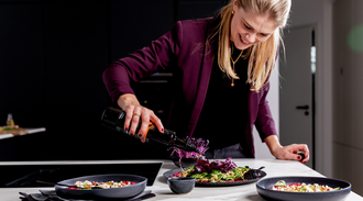 Woman garnishes plate