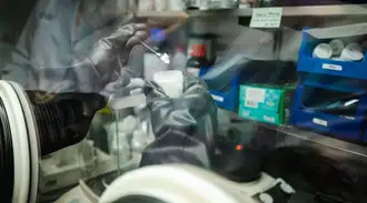 SCHOTT laboratory employee places a sample in a container