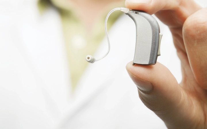 Hearing aid held by a medical doctor