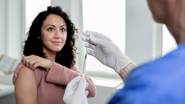 Female in a doctor’s surgery about to receive an injection