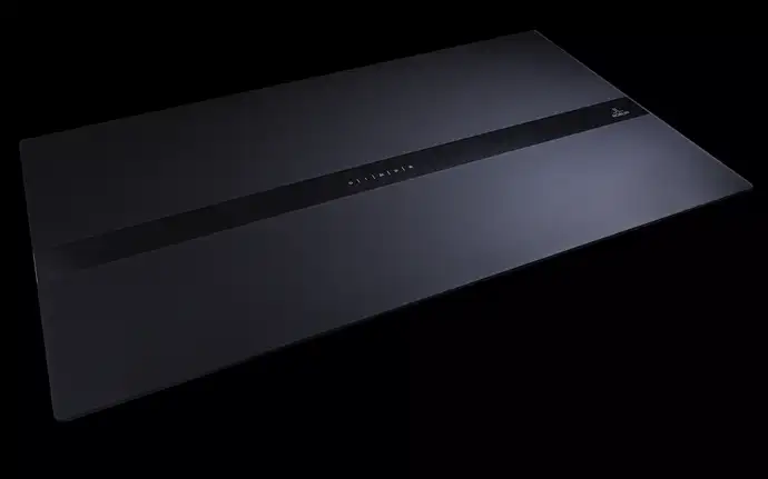 Sleek extractor hood with minimalist design and illuminated control strip on a dark glass surface.