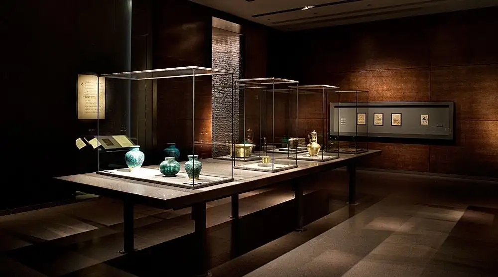 Interior of the Museum of Islamic Art in Doha, Qatar, with series of pots in glass display cases