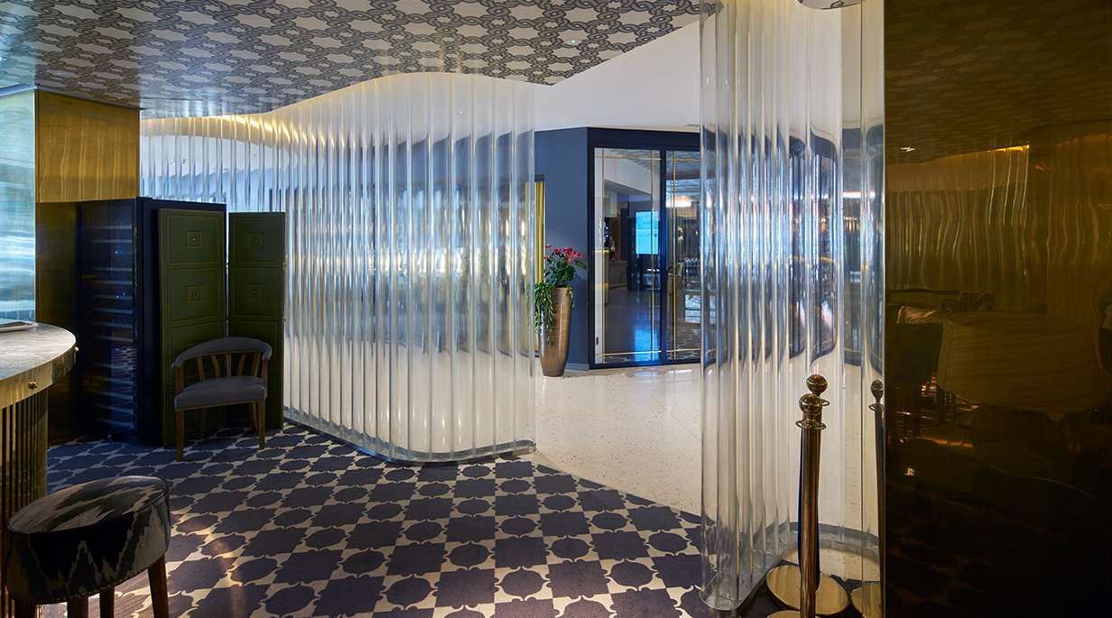 Glass walls of the lobby of the NH Hotel in Brussels 	